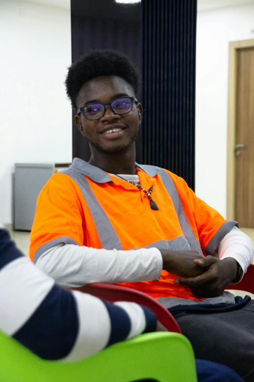 a man in safety vest with orange vest sitting