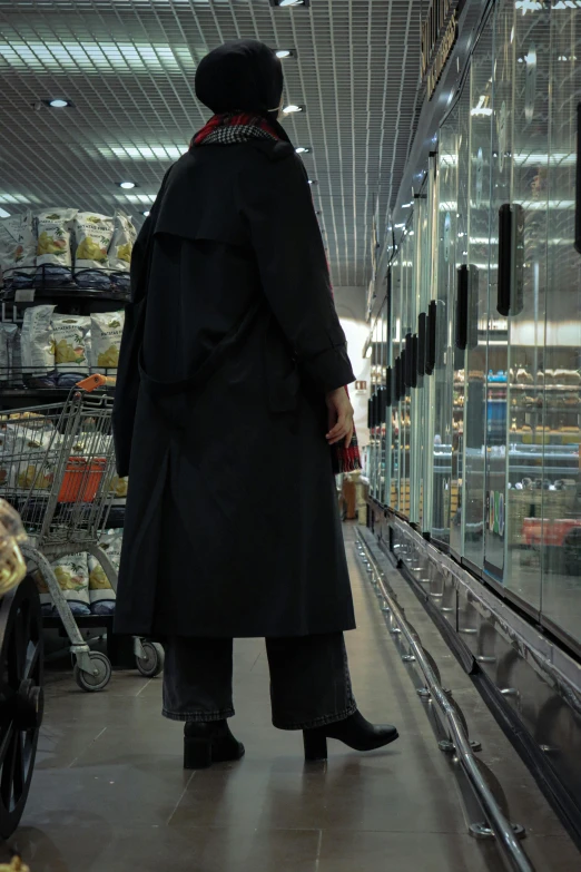 the man in the coat is shopping for stuff