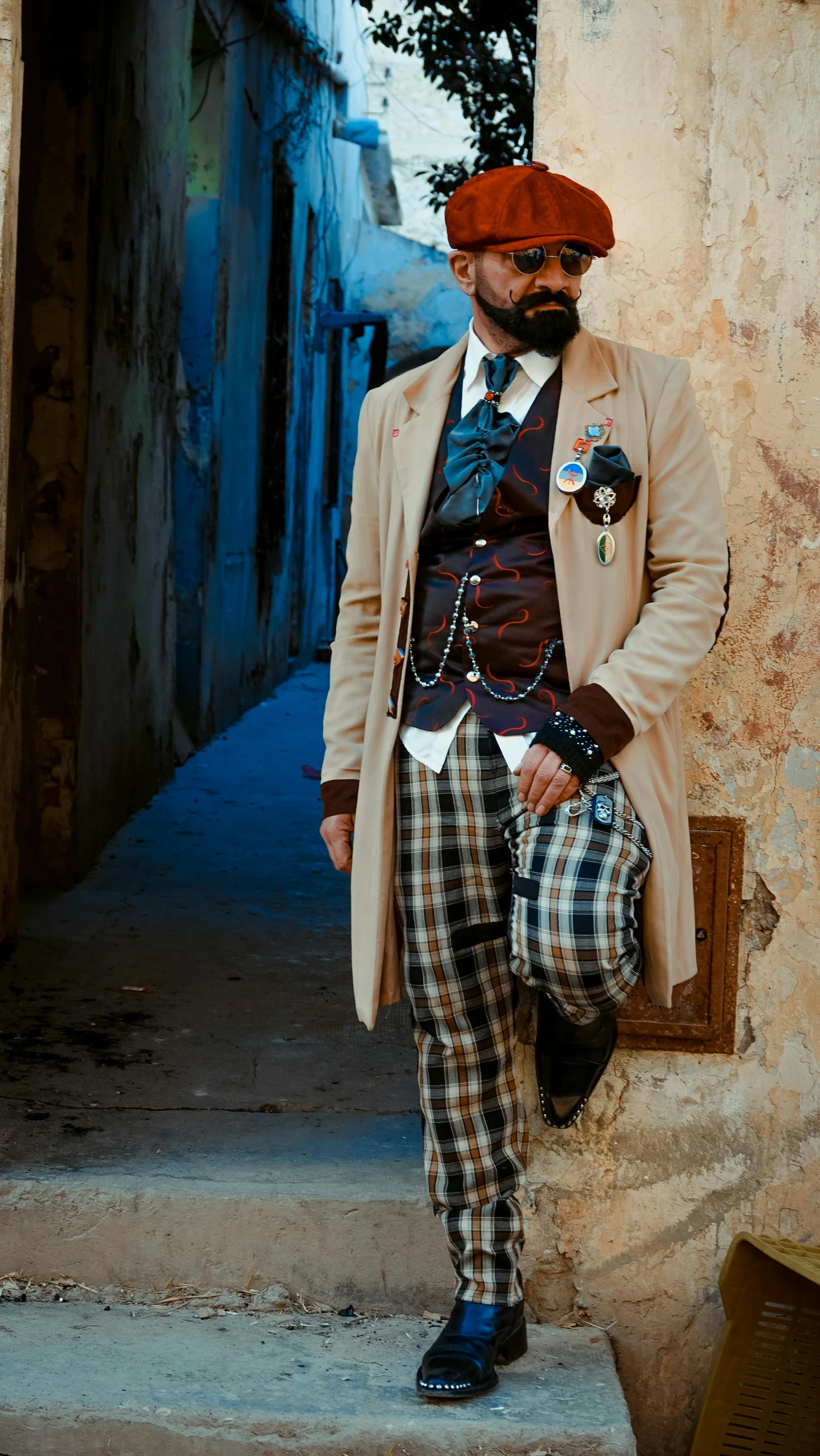 a man dressed in costume is posing by a stone wall