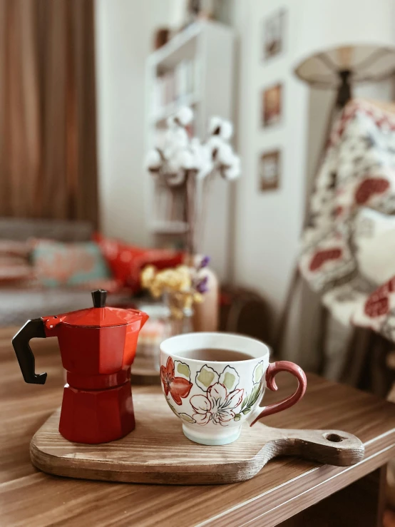 a table with coffee on it with flowers printed mugs