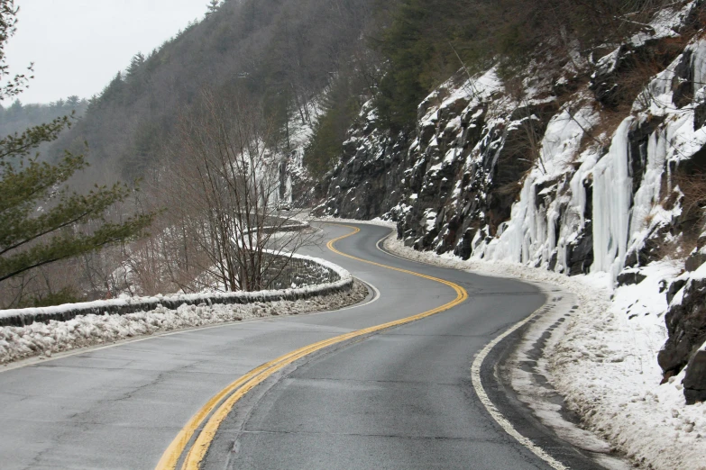 the mountain road has a long curved curve that is a bit over it