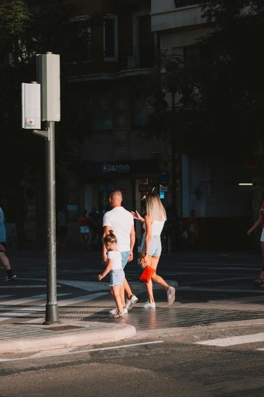 family walks through a city at an intersection