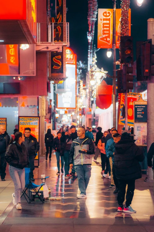 a group of people are walking along a street