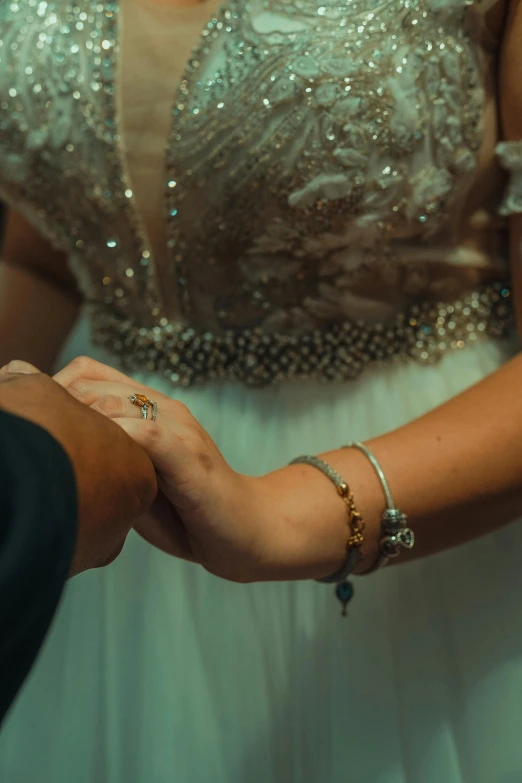 a person holding the hand of a person in a dress