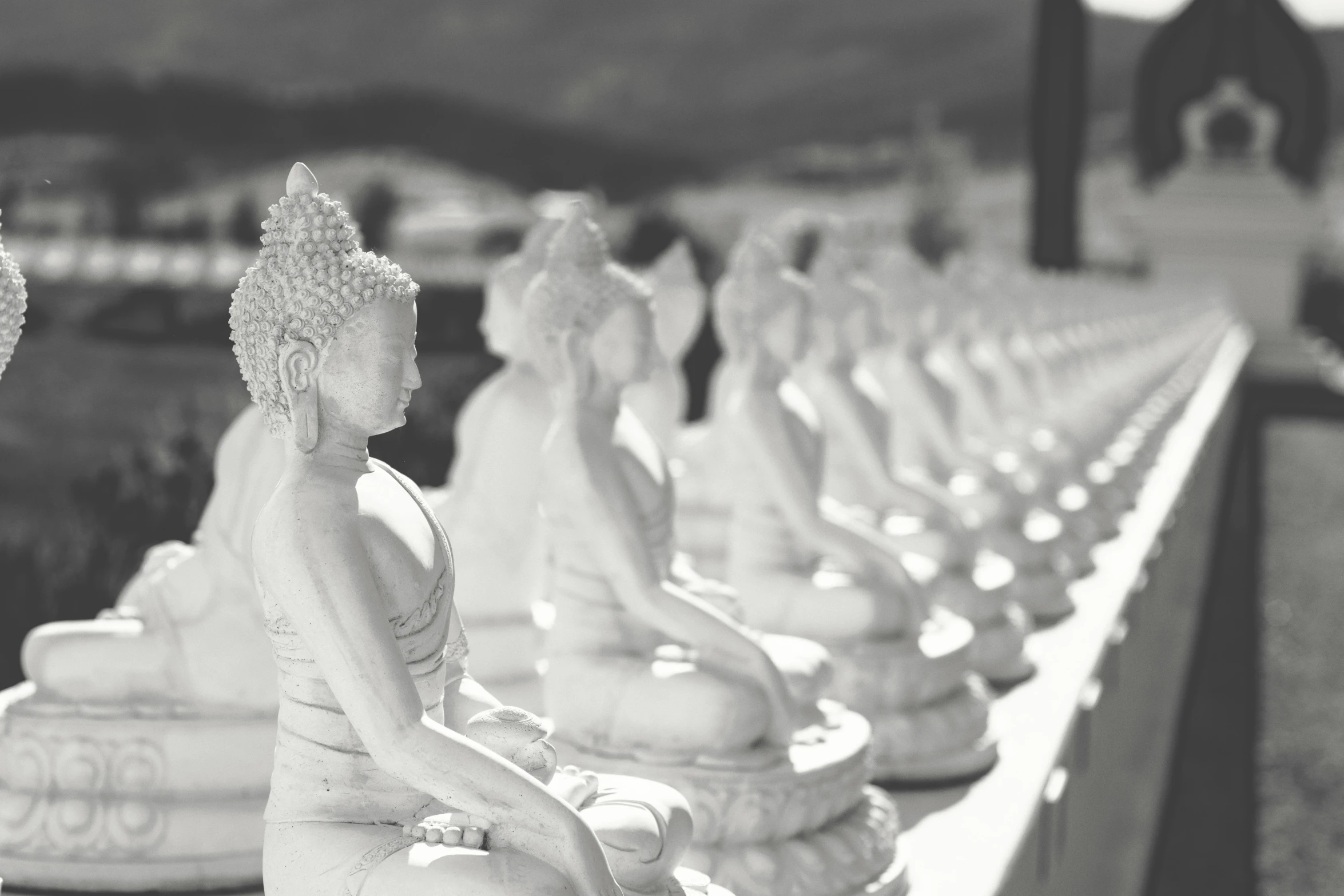 black and white po of the heads and shoulders of four marbled figures sitting next to each other