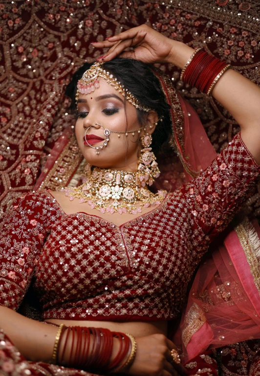 indian woman in wedding red outfit looking away from camera