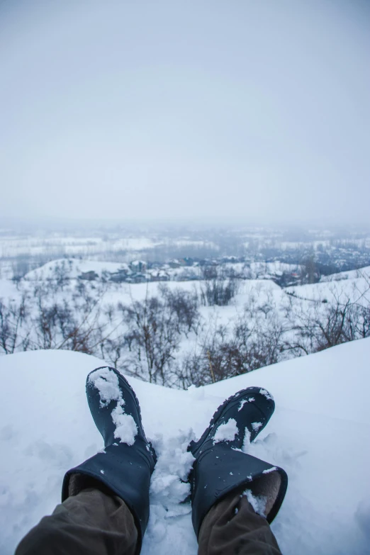 a person's feet that are standing in the snow