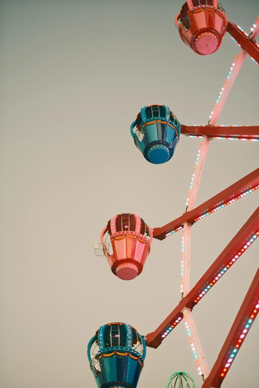 a ferris wheel and light up lights against the sky