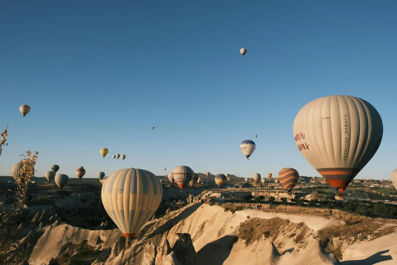 the large balloons are in the sky over the mountains