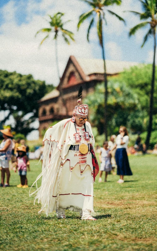 a woman in a native outfit in a field