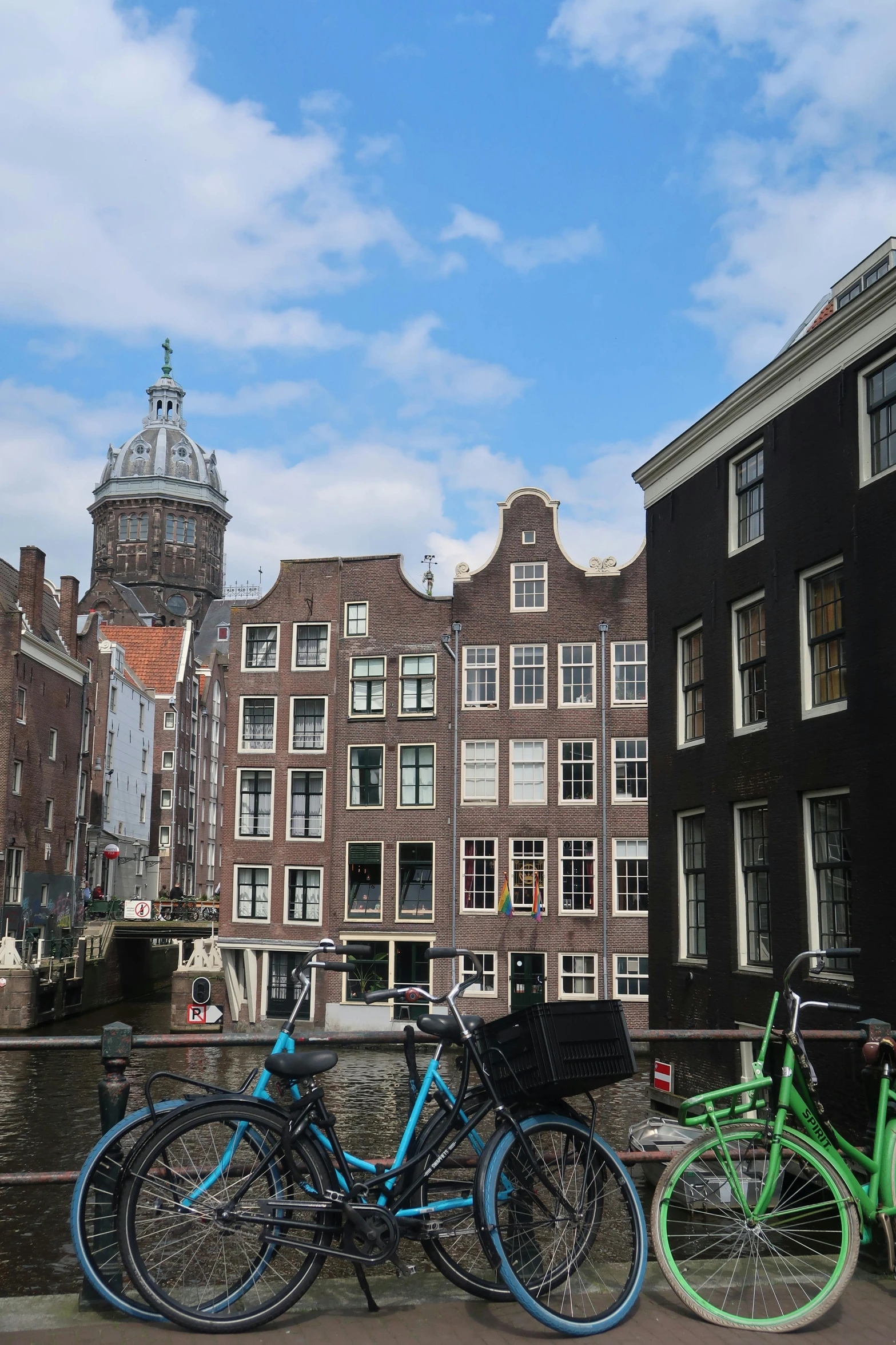 bicycles and cars are parked in front of the building