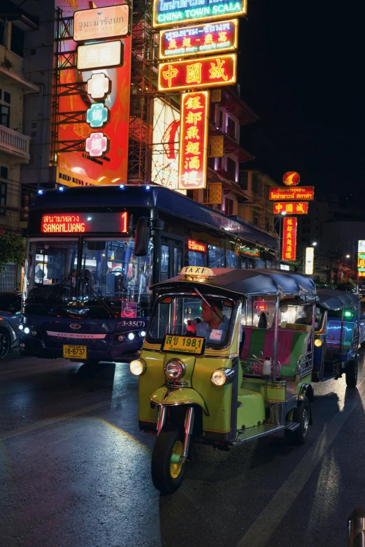 an orange and yellow tuk with people riding in it