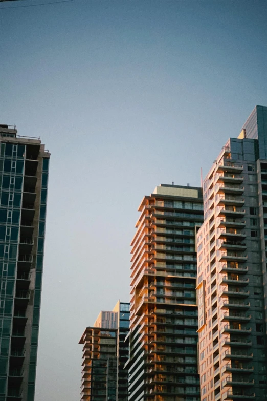 a large kite is flying in front of several tall buildings