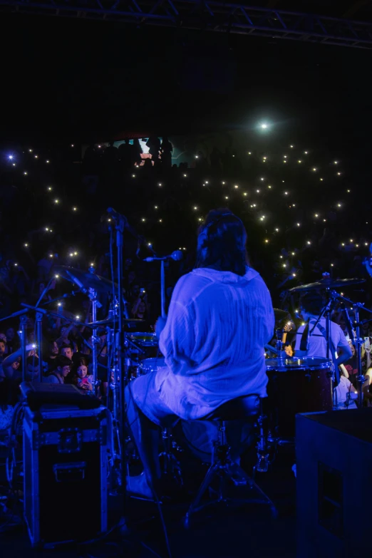 a group of people are playing concert on stage