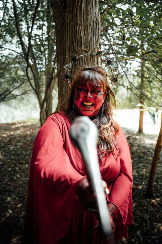 a  with makeup on holding a large metal handle