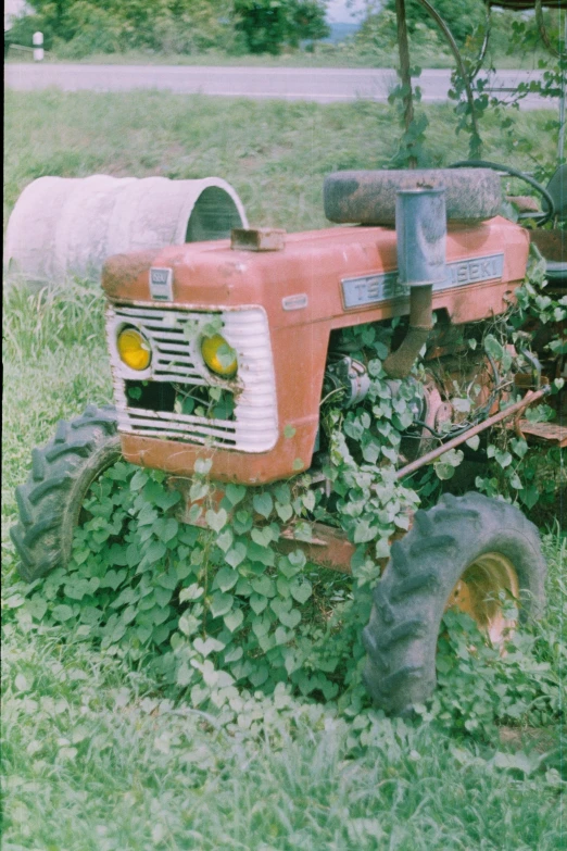 an old tractor sitting in the grass