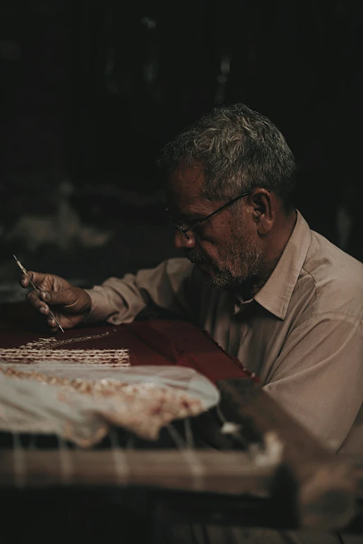 an old man sits at a table with his food