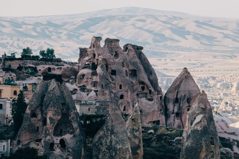 a city and castle in the mountains near the sky