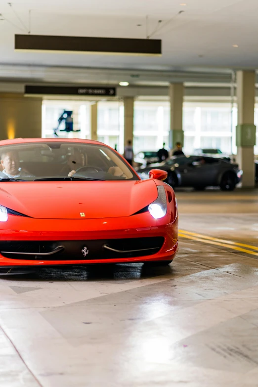 a car in front of several cars parked on the ground