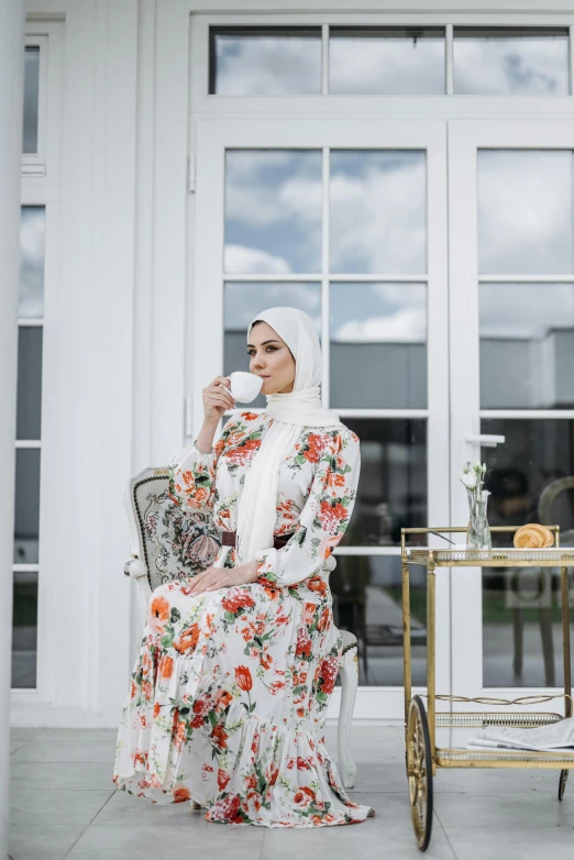 the woman is wearing a white dress and drinking