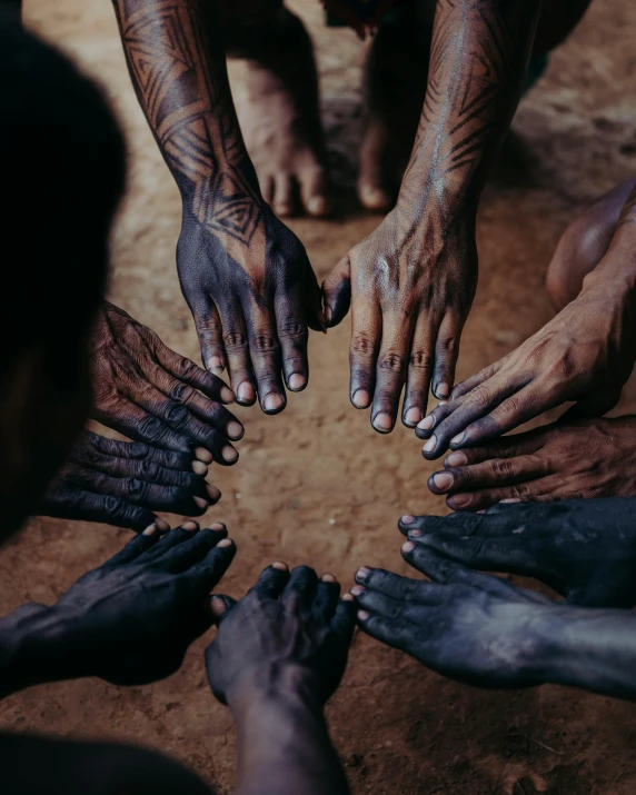 six hands reaching out to touch each other