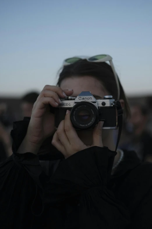 a woman holding up a camera taking a po