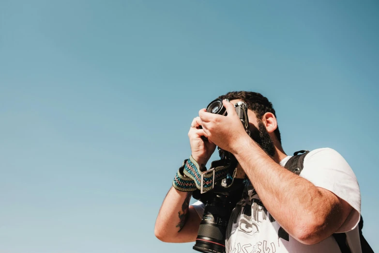 a man in leather jacket taking picture with camera