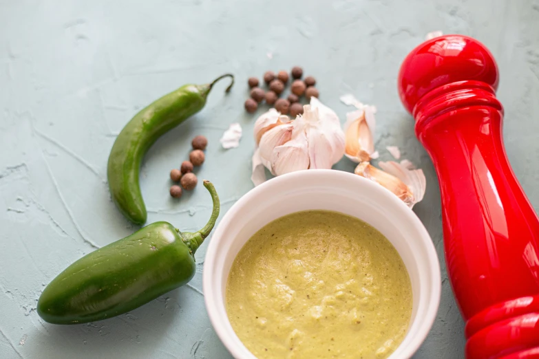 a red pepper, garlic, and other items of food on the table