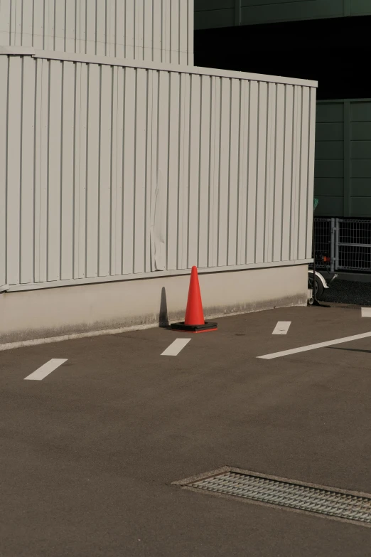 a traffic cone sits next to a small fire hydrant