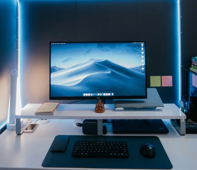 the computer monitor is on on a white desk