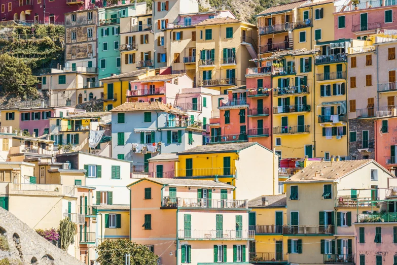 many colorful buildings next to each other on a hillside
