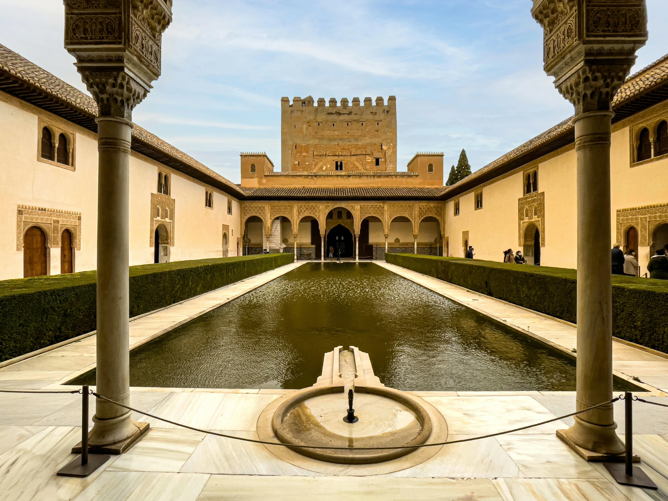 a courtyard that has a fountain in the middle