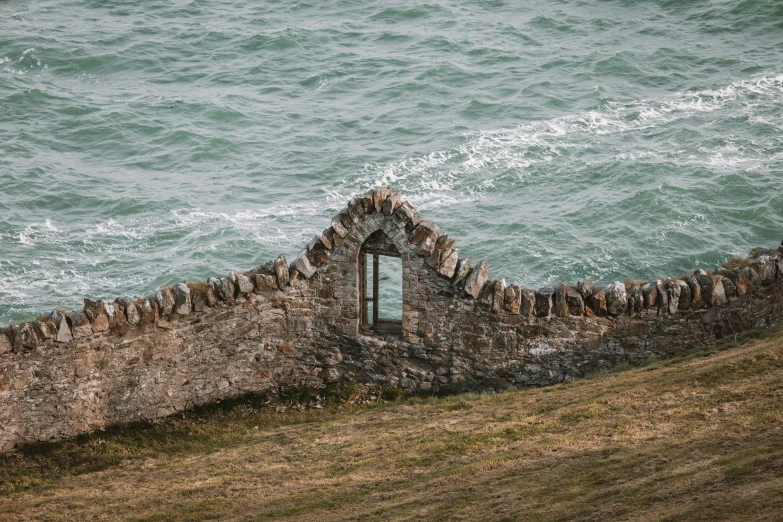 a building is overlooking the ocean and sea waves