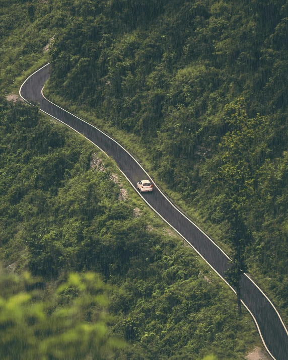 an aerial view of an intersection and road on the side of a mountain