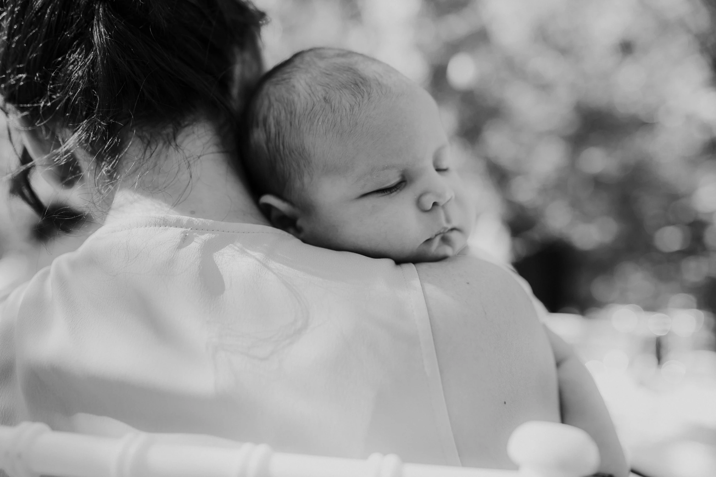 a woman holding a baby in her arms