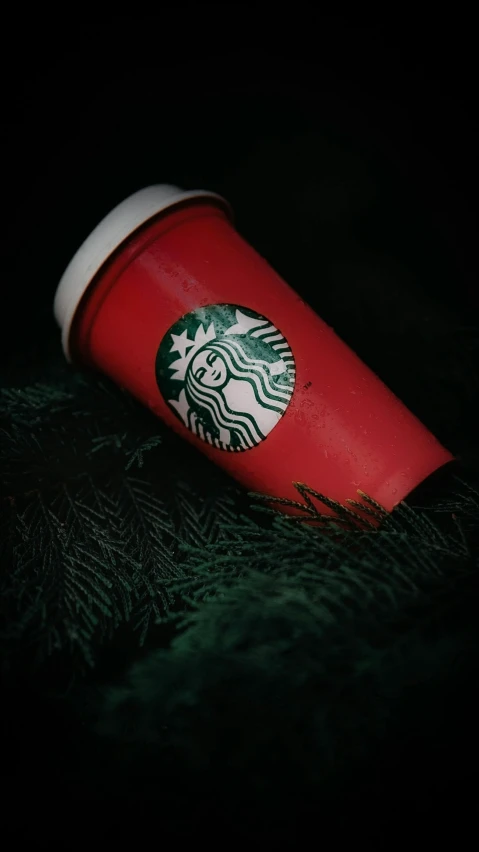 a cup of starbucks in a dark background