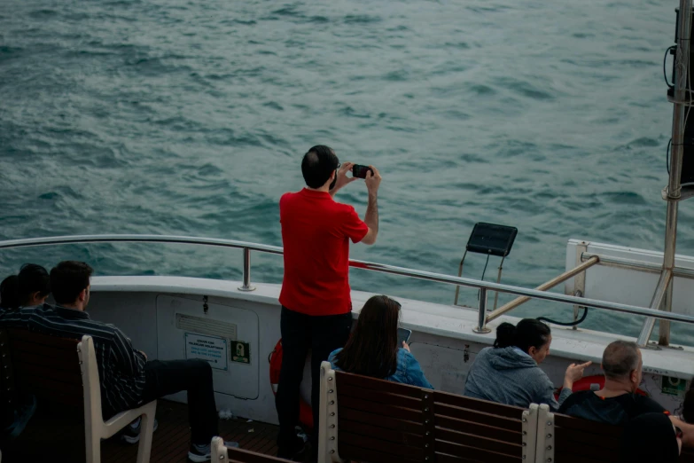 a person on a boat taking pictures of soing