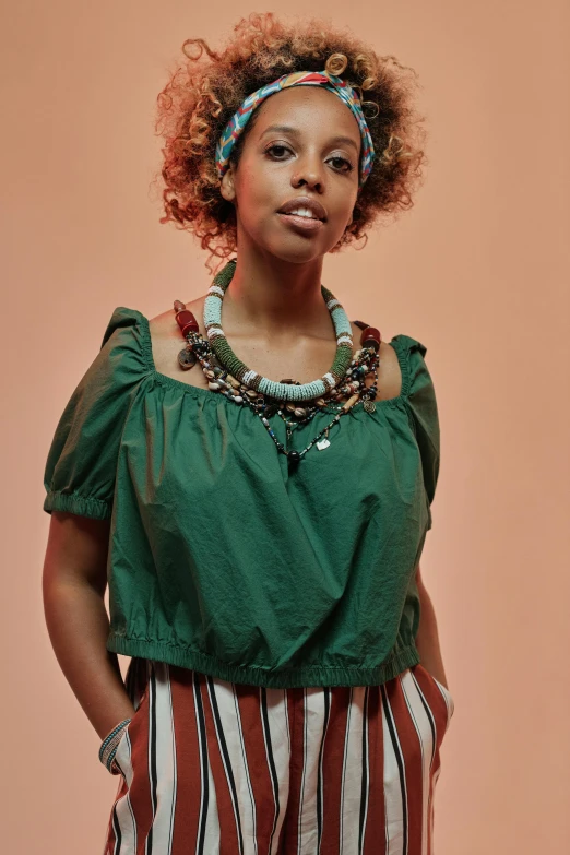 woman with large afro hairs wearing a green blouse