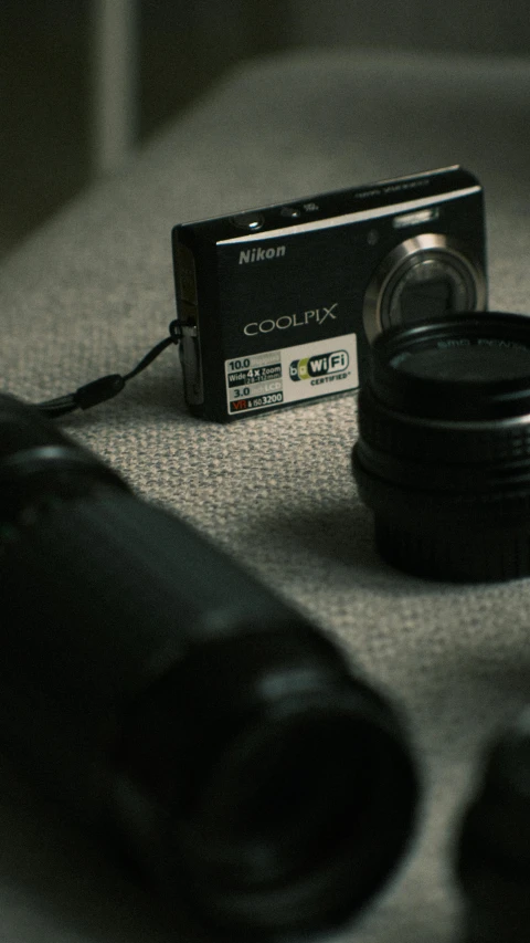 a black camera and some lens accessories on a table