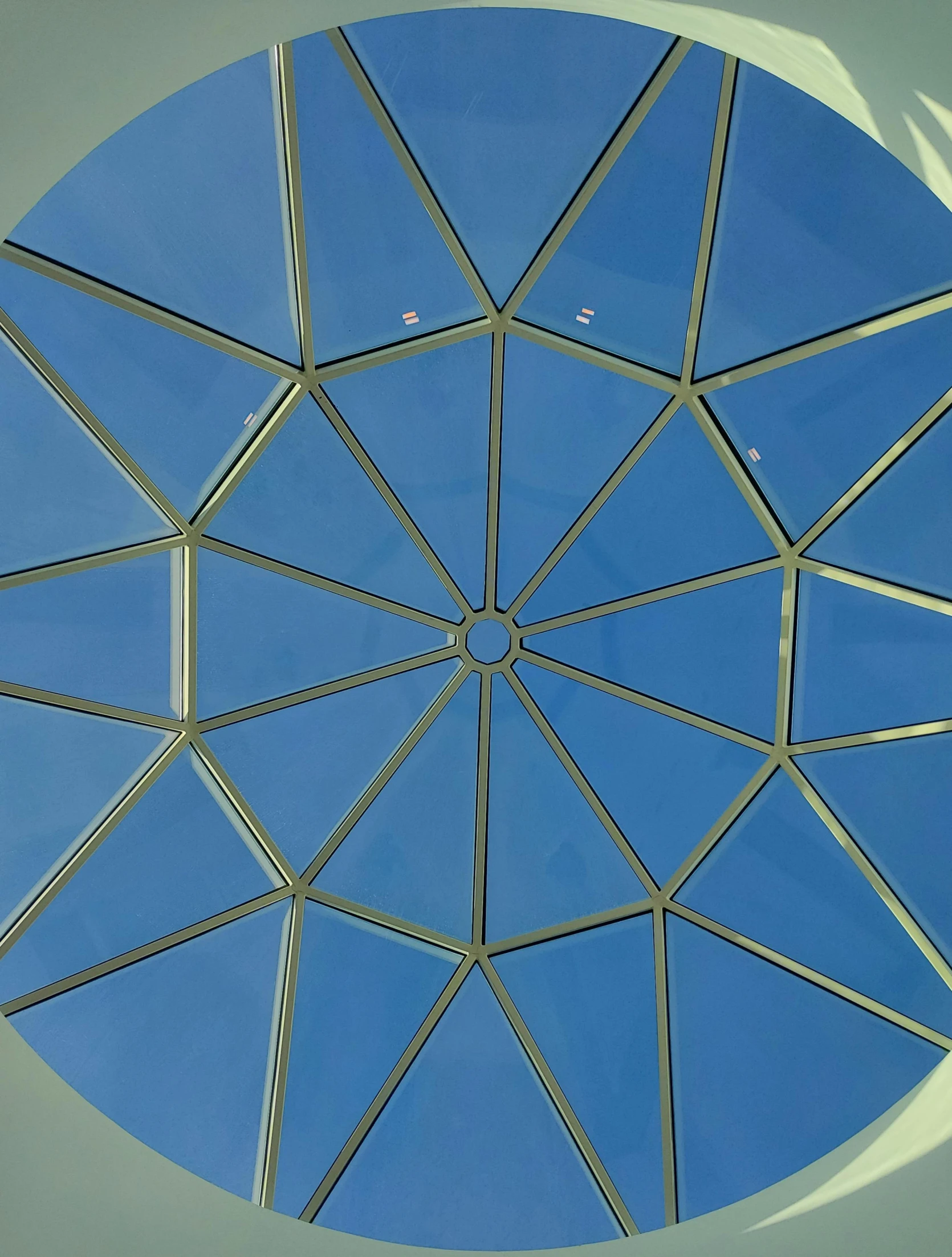 a circle of circles shaped from metal bars with a blue sky background