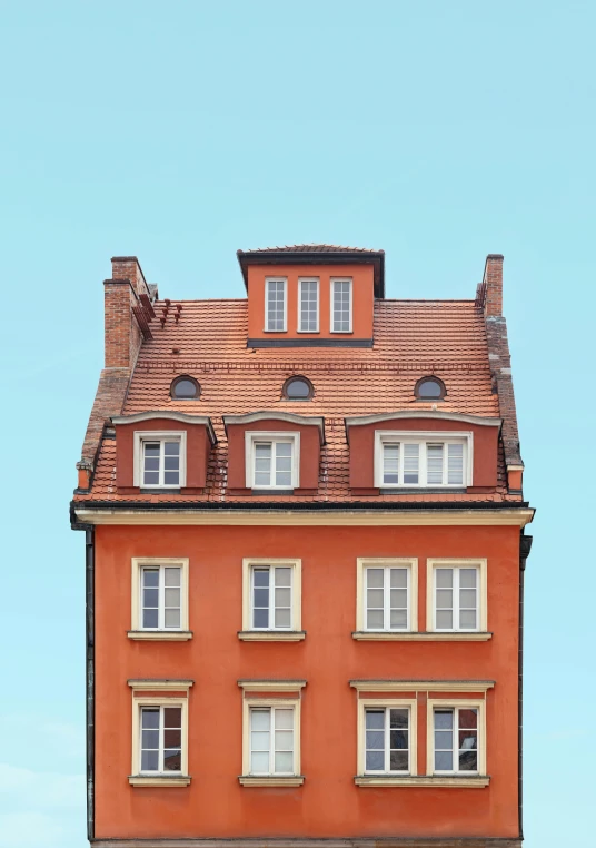 an orange house with a red roof and lots of windows