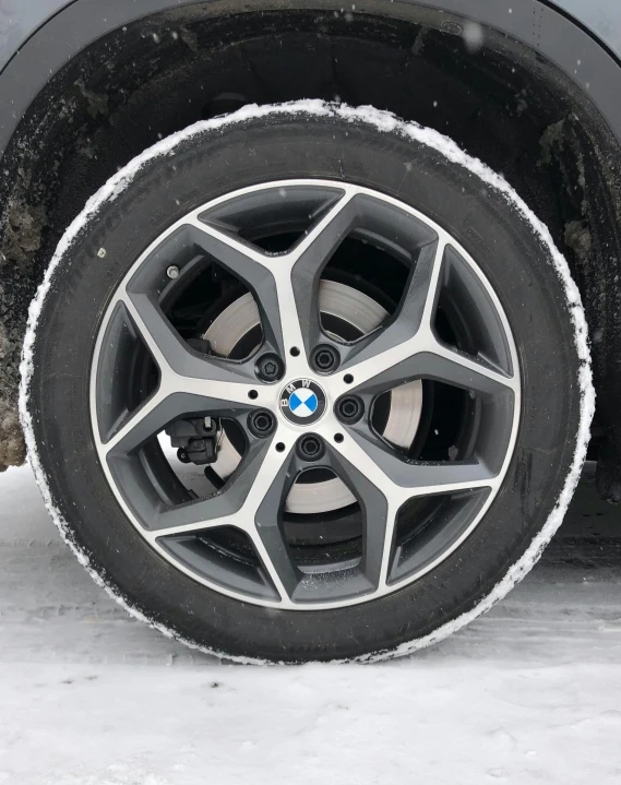 the wheel of the car is covered in snow