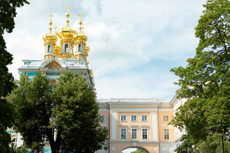 a large white and gold building with a domed dome