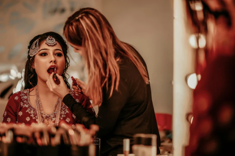 a beautiful woman wearing a headpiece and eating cake