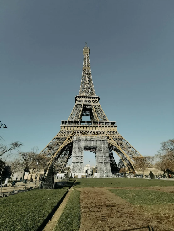 a tall structure on the grass near trees