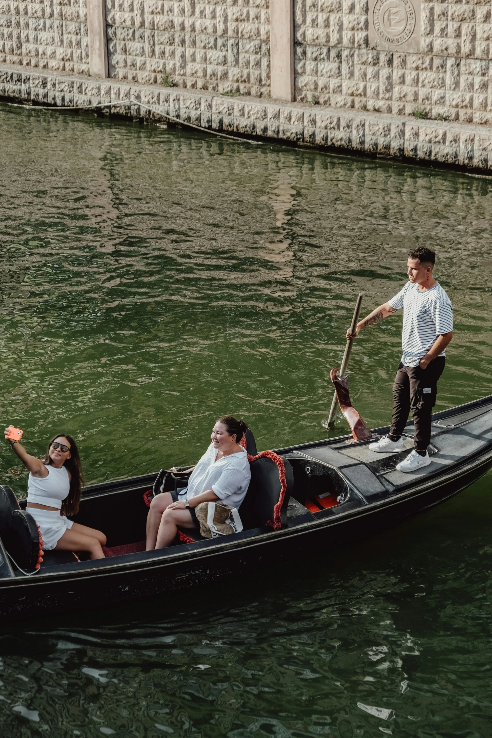 several people riding in the same boat along the river