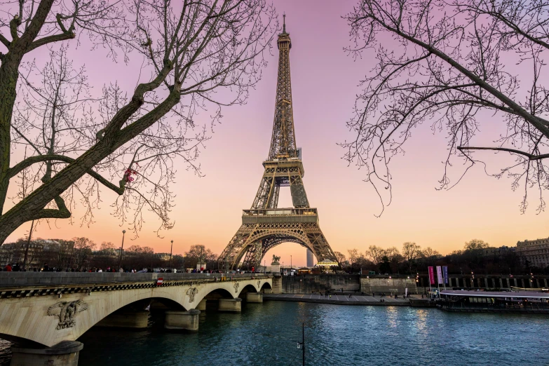 the eiffel tower is lit up at night