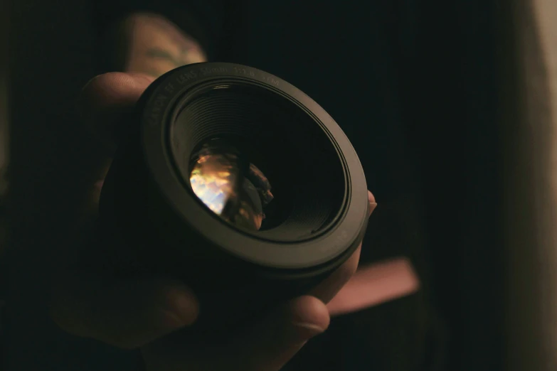 a person is looking into a lens with the light shining in