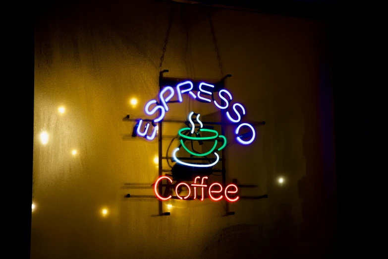 this sign says expresso coffee with a glowing coffee cup on it