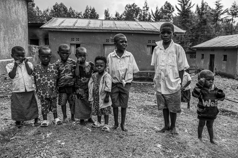 two men with many children outside an old building